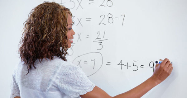 Adult teacher at whiteboard