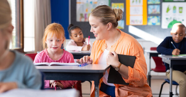 Teacher helping student