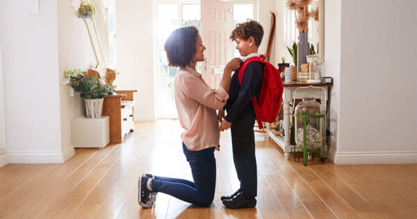 A mother preparing her child to go to school in the morning