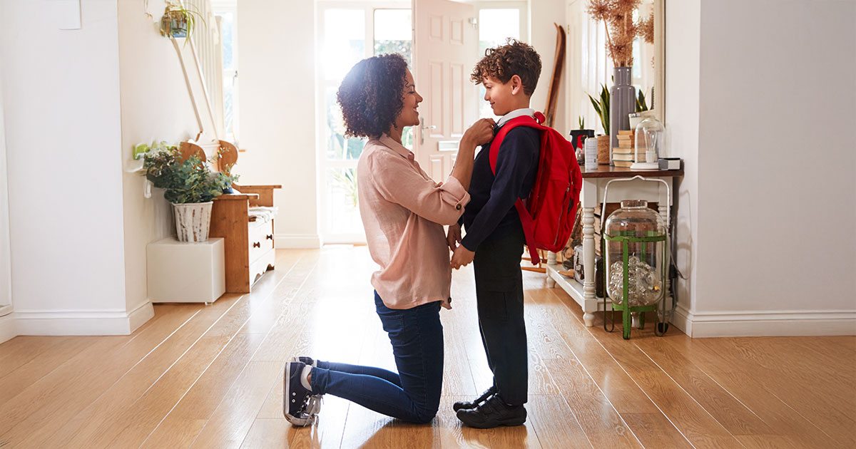 A mother preparing her child to go to school in the morning