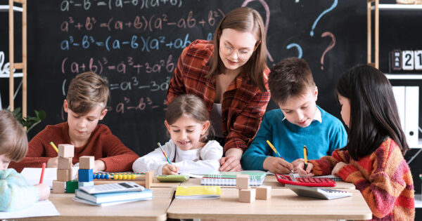 Teacher in math classroom with young students