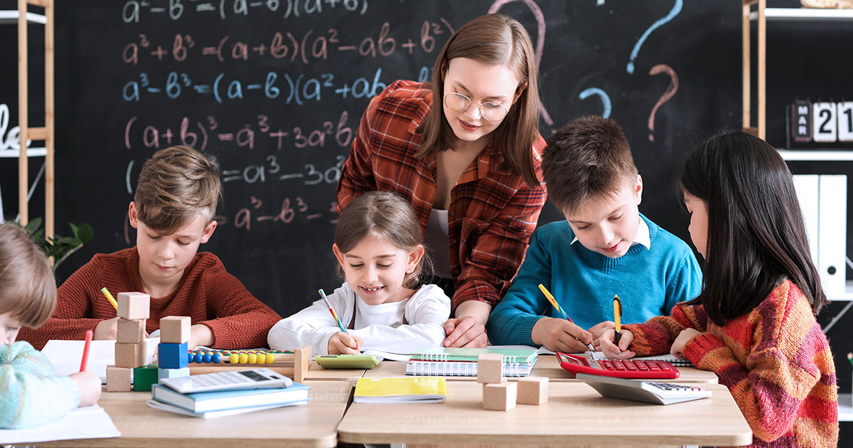 Teacher in math classroom with young students