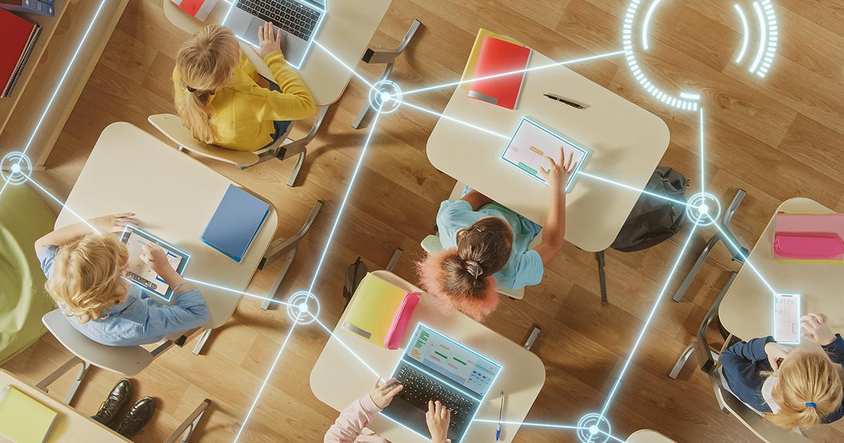Classroom with students at desks, each using a tablet or laptop