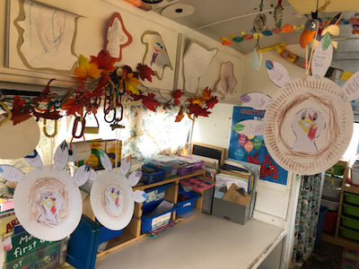 Art projects hanging along the cabinets on COW bus.