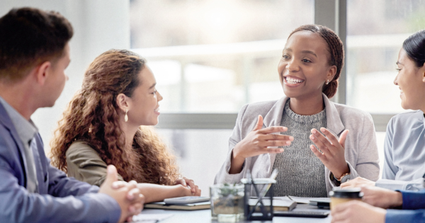 Four educators at a table in conversation