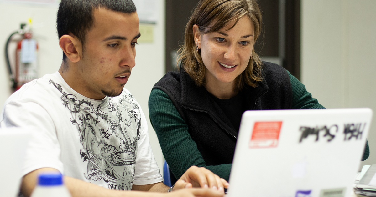 Photo of teacher and student at computer
