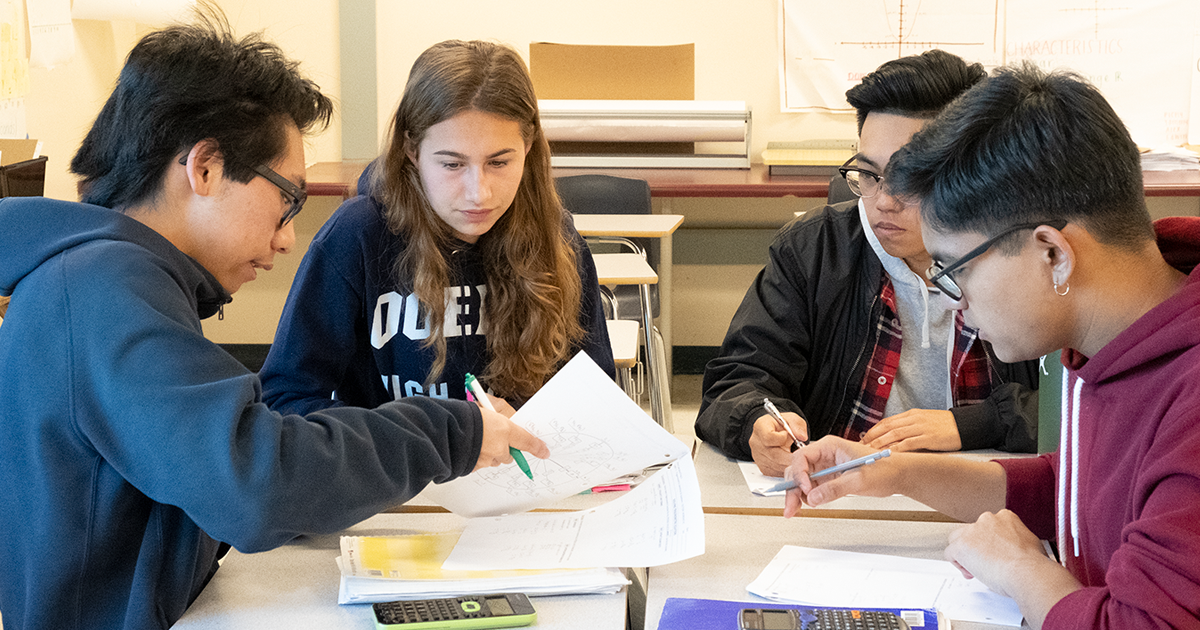 Photo of High School Students working together.